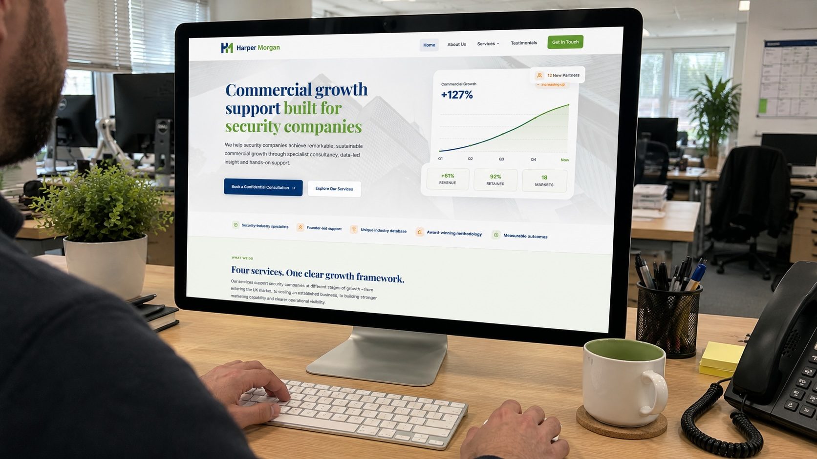 Harper Morgan consultancy website on desktop monitor in office